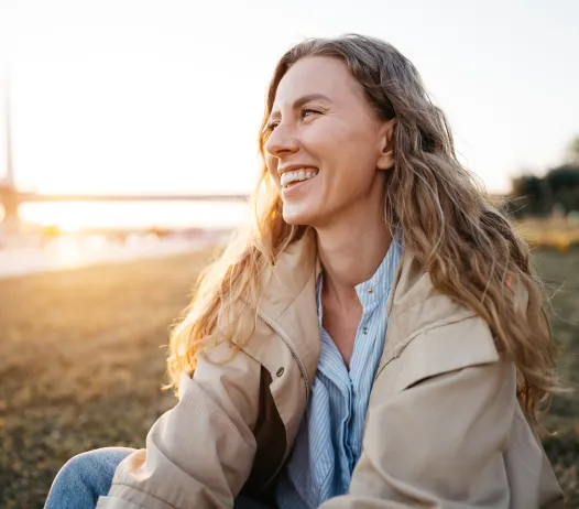 Happy Woman sitting on the beach